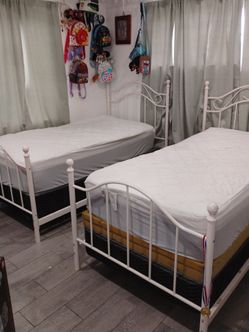 White twin metal beds