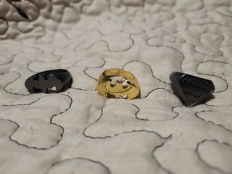 Two Batman rings and one Superman ring