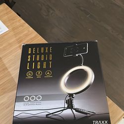 Studio light with detachable phone holder