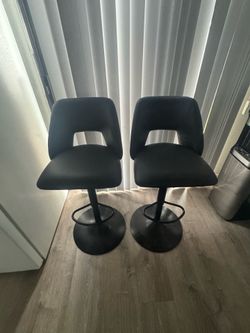 4 Modern Black Bar Chairs with adjustable height.