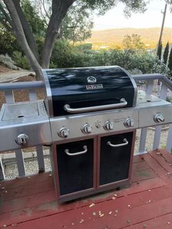 Heavy-duty Fire King 4-burner stainless steel propane gas grill.