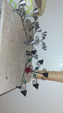 2 silver colored figurines that hold 4 minature candles, and a dark brown colored figurine that holds 5 minature candles, all 3 for $7