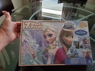 New. Frozen 7 wooden puzzles