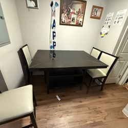 A  Dining Table And Four Chairs