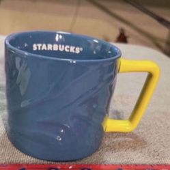CA. STARBUCKS 12 OZ. NEW BLUE WITH YELLOW HANDLE. 