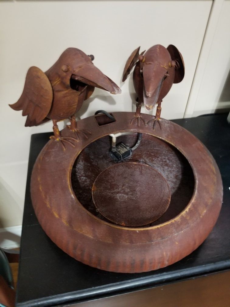 Two Crows drinking water fountain