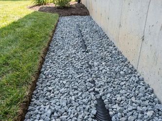 #57 gray gold white rocks gravel French drain retaining wall