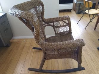 Wingback wicker rocking chair.
