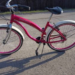  a Kent Del Rio 26-inch women's cruiser bike in magenta. 