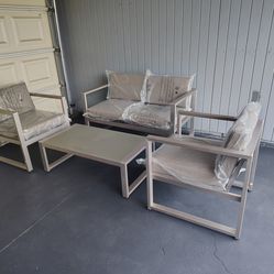 Outdoor patio couch with 2 chairs and coffee table