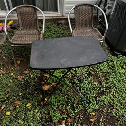 Tow chairs with a table 