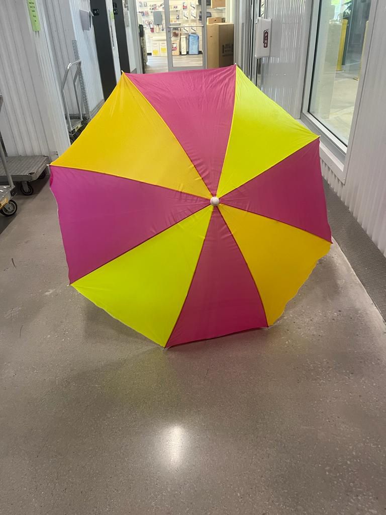 One colorful, beach umbrella, complete  with Anchor For Sand