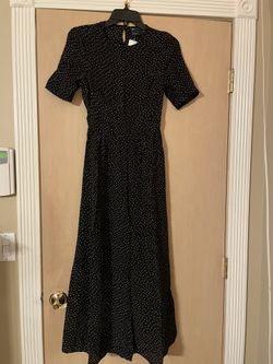 Brand New size Xs women’s black and white polka dot romper. Small open back. Button up neck 