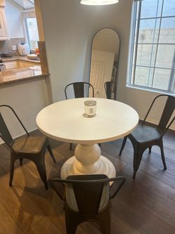 White pottery barn pedestal table with chairs