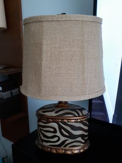 Small animal print lamp with cloth shade.