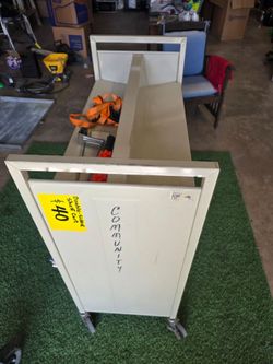 TODAY SUNDAY ONLY 10AM-5PM ! double sided metal book rack with wheels, $10