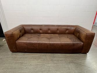 Brown leather tufted couch