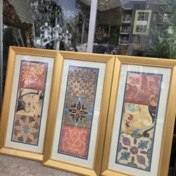 Three framed wall art pieces featuring sari fabric collage, with decorative patterns in shades of turquoise, pink, and gold.