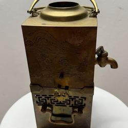 An antique Chinese brass samovar or tea canister.