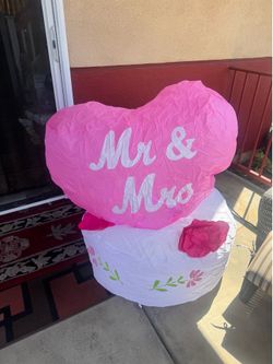 Bright pink Mr & Mrs heart balloon for wedding and bridal party décor. Features bold white lettering that reads “Mr & Mrs.” Lightweight and eye-catchi