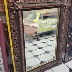 used antique looking carved wall mirror 