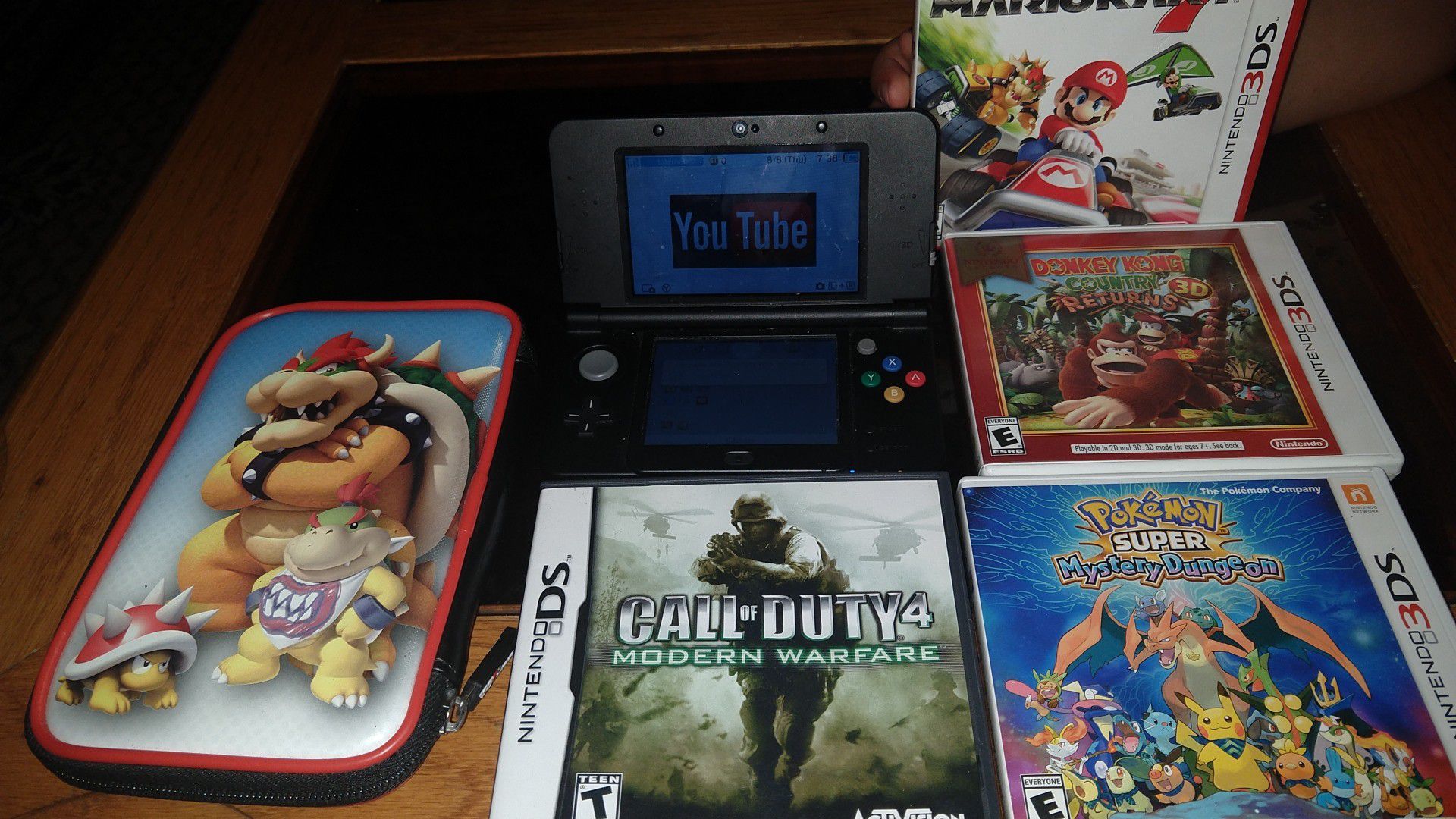 Nintendo 3DS with call of duty 4 Pokemon super mystery dragon 3DS game donkey Kong country returns 3D Mario kart 7 and Bowser case