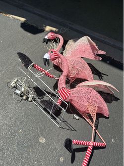 Pink flamingos, pulling sled