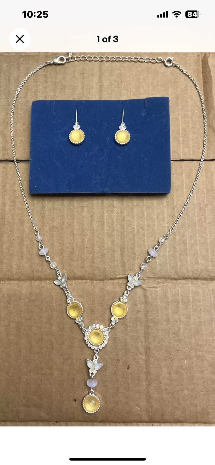 Silver toned Y-drop necklace with yellow rhinestones and iridescent rhinestones.