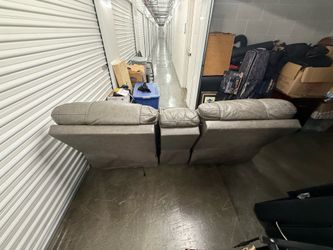 Grey leather power reclining loveseat with console.