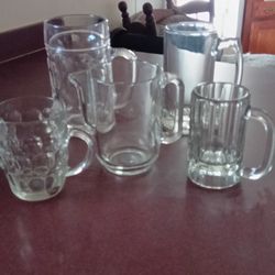 4 Glass Mugs And 1 Mini Glass Pitchers 