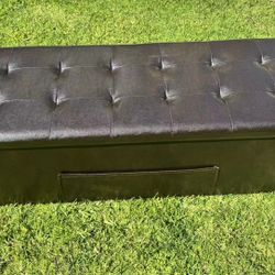 Brown faux leather folding storage stool.