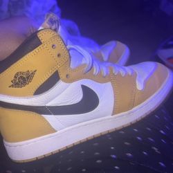 the Nike Air Jordan 1 Retro High OG in the "Yellow Ochre" colorway. 