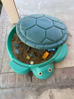 Little Tikes turtle sandbox with lid.
