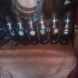 These Are Collector Edition Coca Cola Bottles Full Of Coca Cola But I Wouldn't Recommend Drinking Any  Of Them.  They Are "Best Of The Bay Series. $20