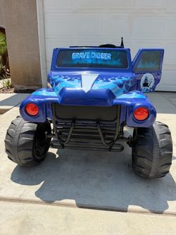 Monster Jam Grave Digger 2-Seater Kids Electric Ride-On Truck