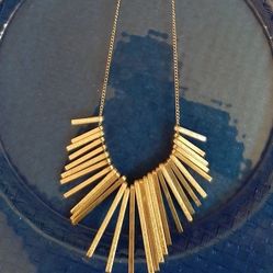 Stylish silver tone necklace with unique design.