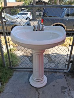 Pedestal sink 24"w×21"×34"tall.