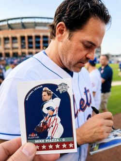 Mike Piazza In-For sale is a beautiful Mike Piazza in-person signed 2002 Topps card, featuring a bold blue autograph across the front and a great phot