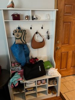 Shelf, hooks, bench seat, and shoe cubbies furniture piece.
