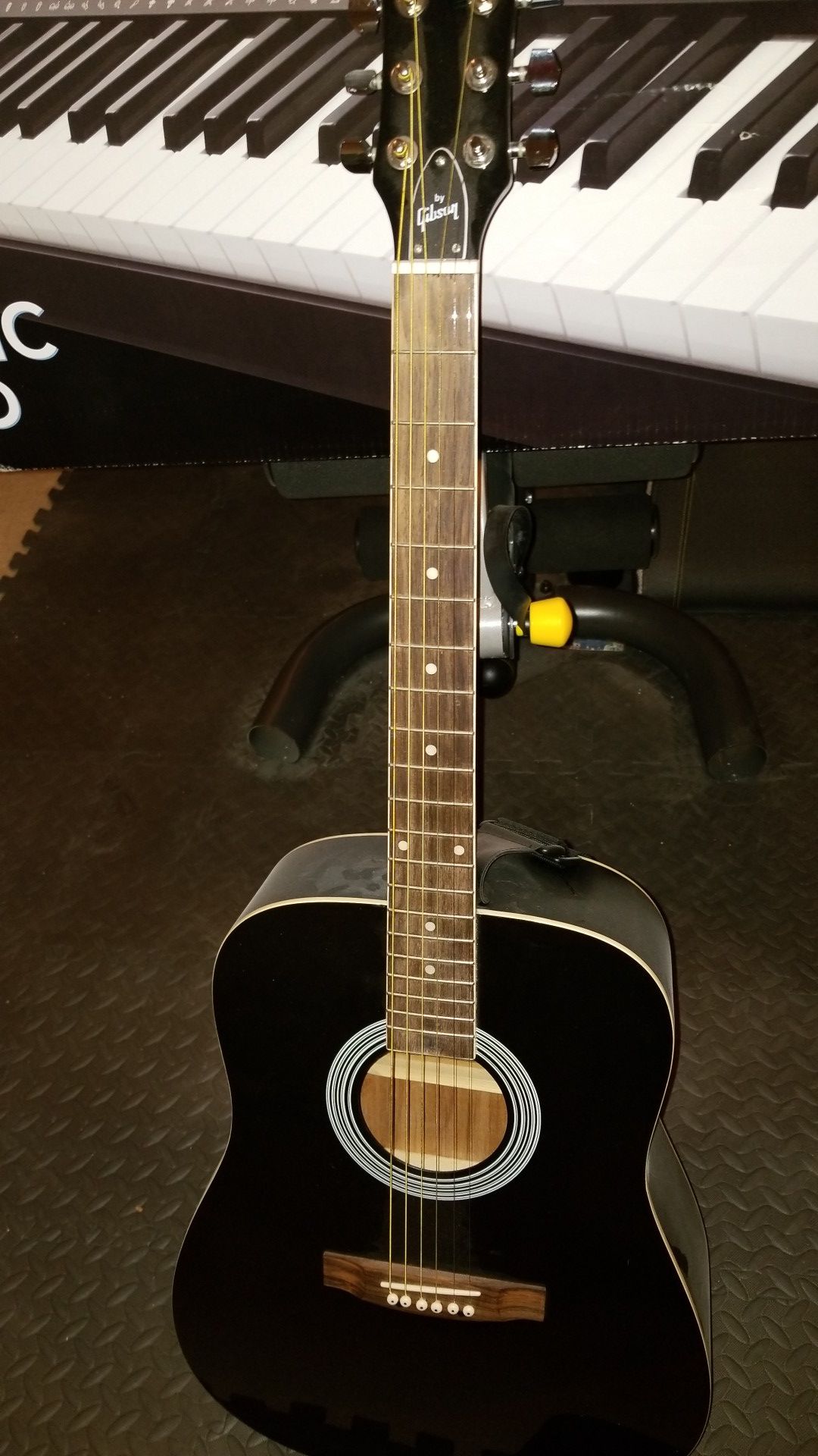 Acoustic Guitar with soft case, clip, and strap to hold guitar while playing