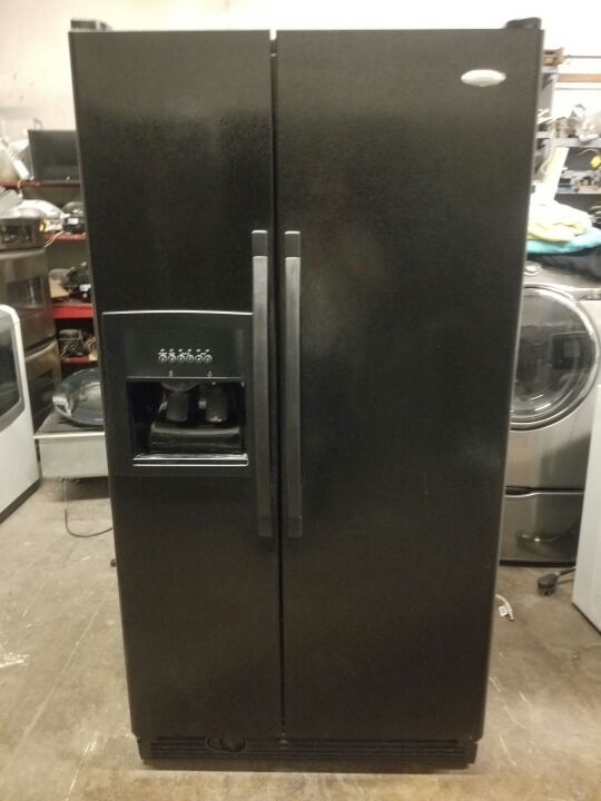 Whirlpool side-by-side refrigerator with water and ice to the door.