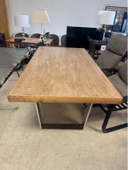Beautiful industrial-style dining table featuring a solid wood top paired with U-shaped metal legs - Retail: $1599