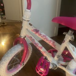 Pink and white toddler bike