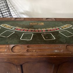 Vintage wooden blackjack table with card slots. 