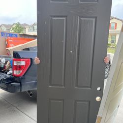 Solid wood exterior door asking $200 and an interior three panel white door asking $100