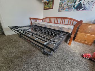 Wood frame Day Bed with rolling trundle. Twin mattress size