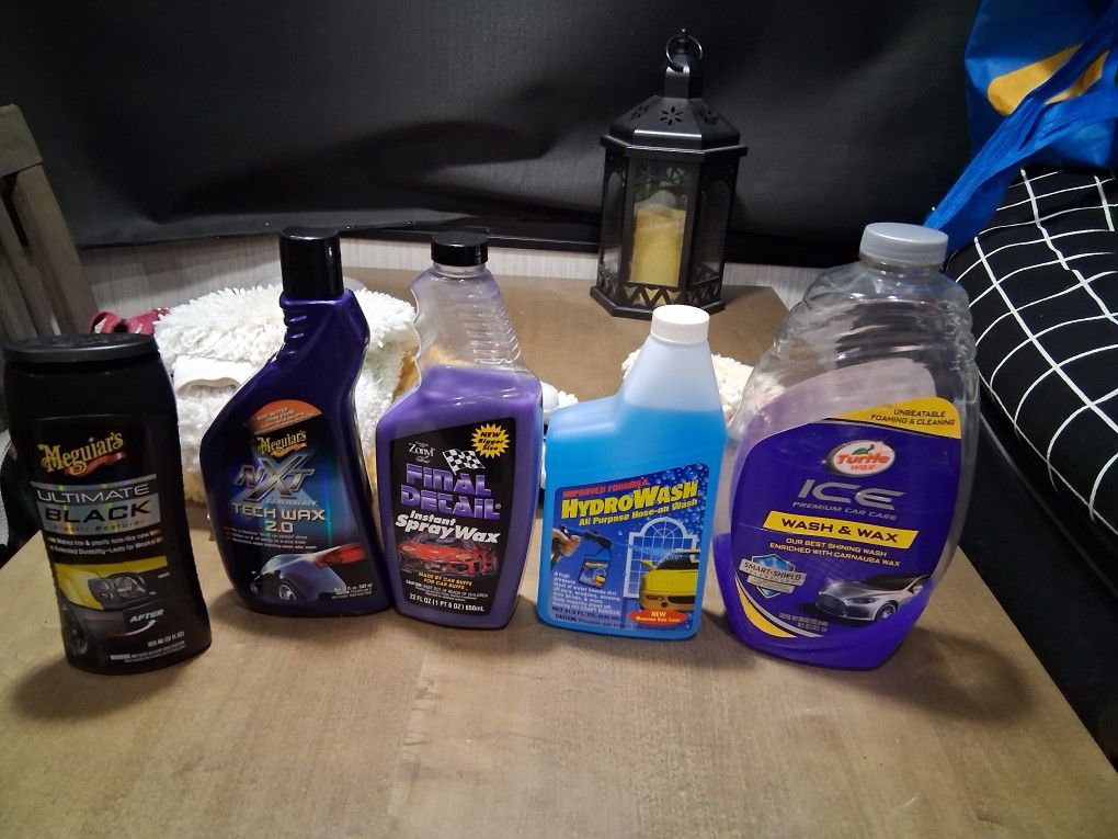 Car wash, wax, Black plastic restoration cleaner and washing mitts. 