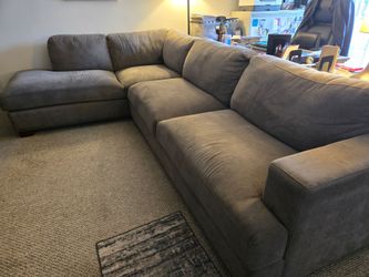 Gray sectional with chaise lounge and ottoman
