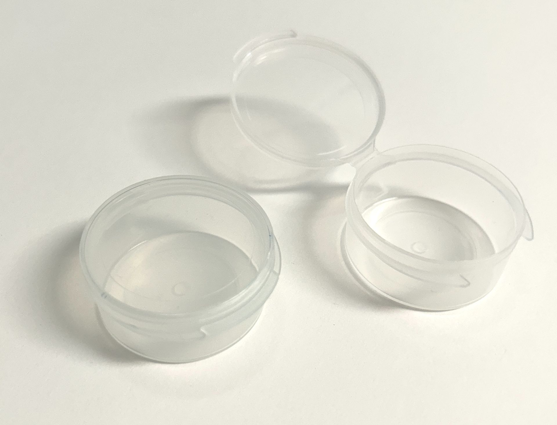 Small lidded plastic storage cups