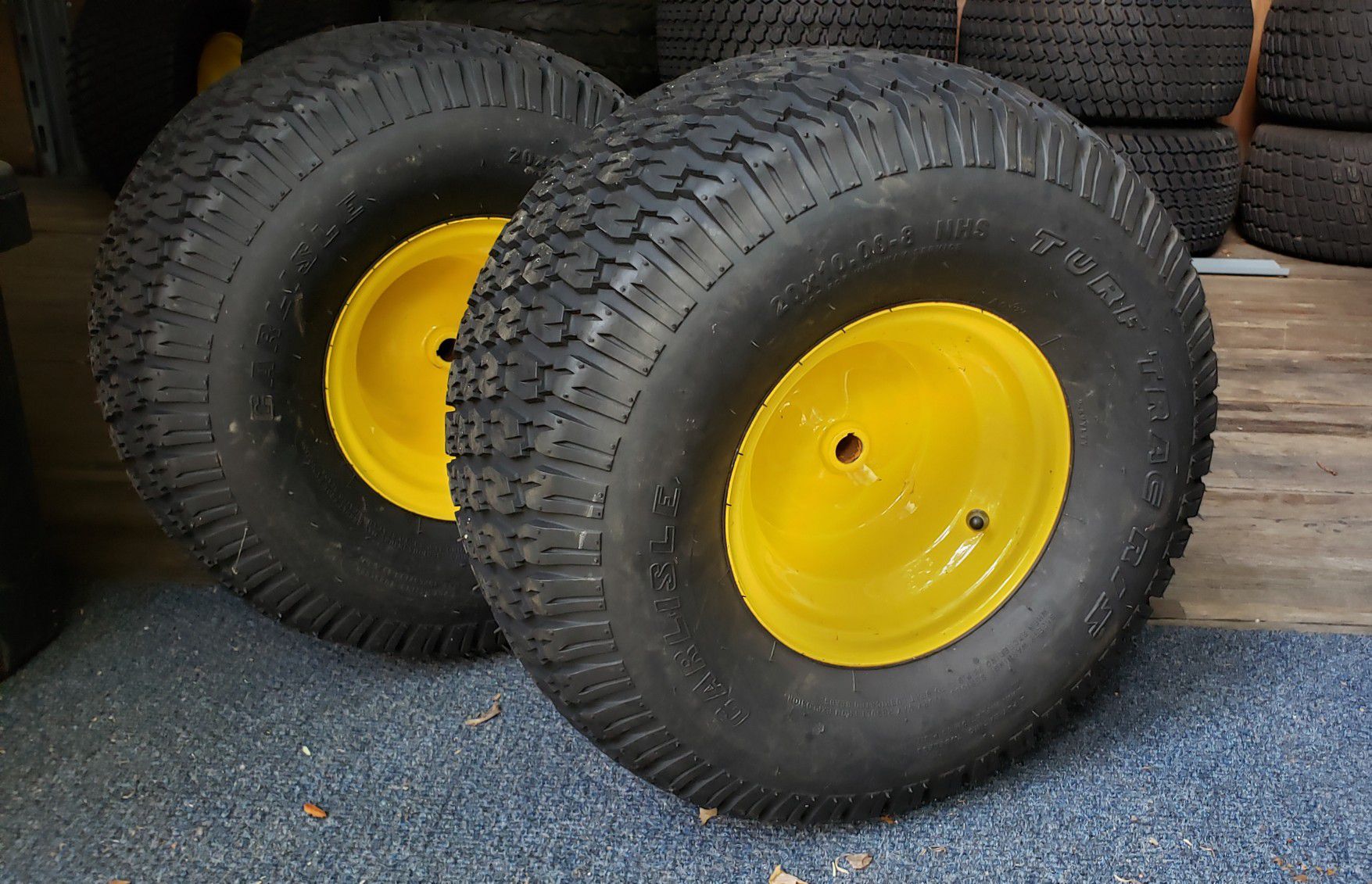 Pair of 20x10-8 Carlilse TurfTrac R/S 2 ply lawn mower tires on JD yellow wheel